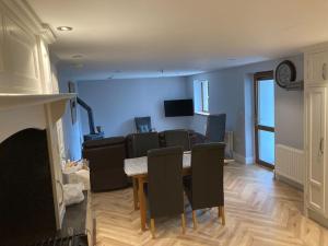 a living room with a table and a couch at RedBayBeach-House in Glenariff