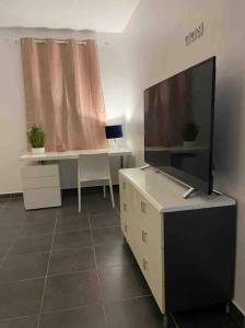 an office with a desk and a large screen tv at VILLA FRUIT A PAIN T2 in Cayenne +11 photos