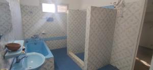 a bathroom with a blue toilet and a sink at La Villa Tcha Tcha in Lomé