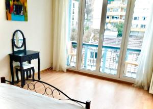 a bedroom with a bed and a mirror and a window at El Hamra - cozy - by PA in Luzern
