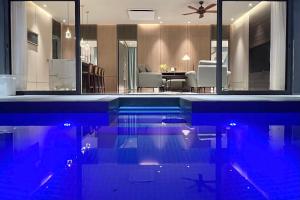 a house with a swimming pool with a living room at Looma Private Pool Villas in Pantai Cenang