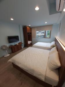 Posteľ alebo postele v izbe v ubytovaní 旅途中海邊民宿