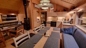 a kitchen and dining room with a table and chairs at Heimstølen - Cabin at Sørbølfjell in Flå