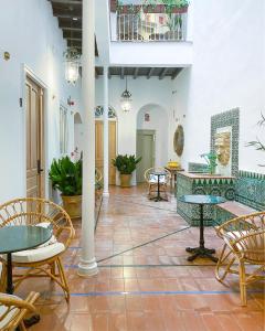 a room with tables and chairs in a building at Casa Bailen Sevilla in Seville