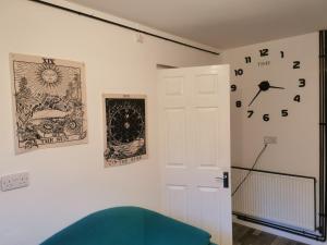 a room with a door and a clock on the wall at 116 maison dieu Road room B in Dover in Dover