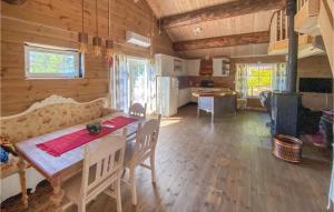 a dining room and kitchen with a table and chairs at Nice Home In Aust-torpa With Kitchen in Aust-Torpa