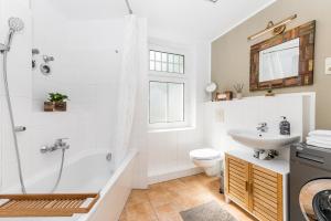 ベルリンにあるstadtRaum-berlin apartmentsのシャワー、トイレ、洗面台を備えたバスルーム +26枚の写真