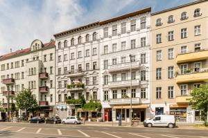 a large white building with cars parked in front of it at stadtRaum-berlin apartments in Berlin