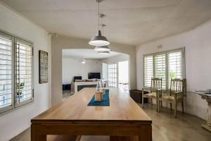 a dining room with a wooden table in a room at Magnificent beach house with stunning ocean views! in Zinkwazi Beach