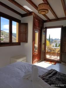 a bedroom with a bed and a view of a patio at Carmen de la Bailaora in Granada