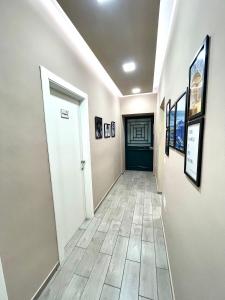a hallway with a door and pictures on the walls at Valentine’s house in Naples
