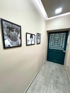 a hallway with three framed pictures on a wall at Valentine’s house in Naples