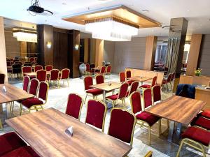 a conference room with wooden tables and chairs at Hotel Ruturaj Regency in Dhule