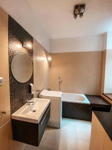 a bathroom with a sink and a bath tub at Hostel Rynek22 in Gliwice