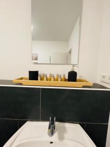 a bathroom with a sink and a mirror at schönes Apartment - Netflix-Nespresso in Duisburg +8 photos