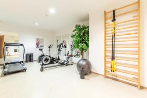 a gym with treadmills and bikes in a room at Hotel Tia Monte Nauders in Nauders