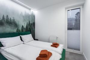 Posteľ alebo postele v izbe v ubytovaní Z Widokiem Apartamenty Świerkowe 10