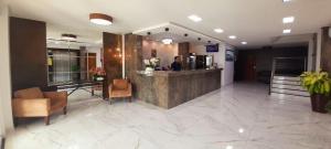 a lobby of a hotel with a reception desk at Hotel Sandis Mirante in Santarém