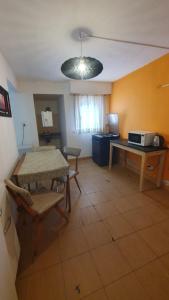 a living room with a table and a dining room at Habitacion economica con estacionamiento Necochea in Necochea