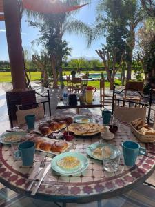 einen Tisch mit Teller mit Speisen darüber in der Unterkunft Teacook Marrakech in Ouled el guerne