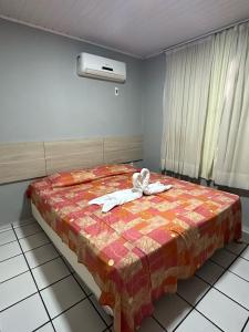 A bed or beds in a room at Hotel Pousada Villa Marina