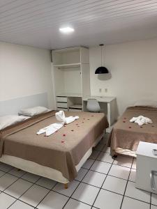 A bed or beds in a room at Hotel Pousada Villa Marina