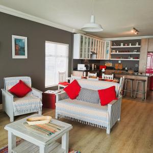 a living room with two chairs and a table at 501 Beach Club in Mossel Bay