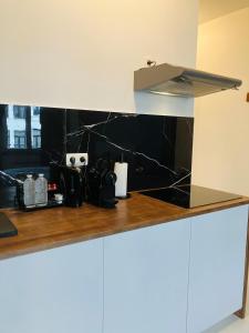 a kitchen with a black marble counter top at Suikerrui 16 App 103 in Antwerp