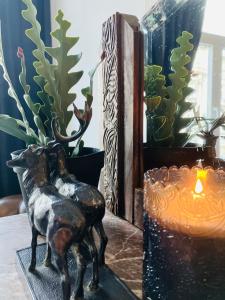 a statue of a dog on a table next to a candle at Suikerrui 16 App 103 in Antwerp