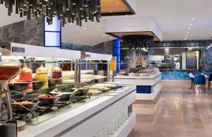 a buffet in a restaurant with food on display at Crowne Plaza Florya Istanbul by IHG in Istanbul