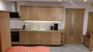 a kitchen with wooden cabinets and a sink at Hintergugg in Mittersill