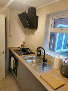 a kitchen with a sink and a stove at 116 Maison Dieu Road Room C in Dover in Dover