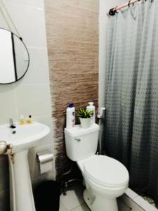 a bathroom with a toilet and a sink at Natalie's Villa in Iloilo City