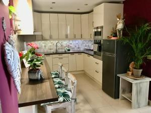 kuchnia ze stołem, krzesłami i lodówką w obiekcie Vivienda Vacacional Vaiana w mieście Las Rosas