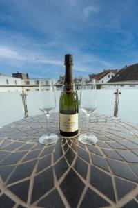 a bottle of wine and two wine glasses on a table at -Zentrale Wohnung-Balkon-Desingerküche- in Bielefeld