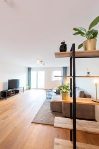 a living room with a couch and a table at -Zentrale Wohnung-Balkon-Desingerküche- in Bielefeld