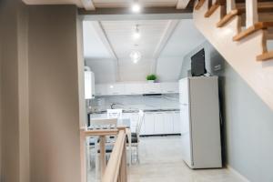 a kitchen with a refrigerator and a table and chairs at Апартаменти Гармонія in Mizhhirya