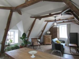 uma sala de estar com vigas de madeira e uma mesa em chez LISON, HEBERGEMENT DE CHARME EN MADIRAN 