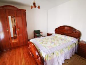 a bedroom with a bed and a dresser at Casa Raquel in Pedreña