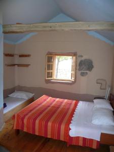 a bedroom with a bed and a window at Sage House in Trpanj