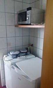 a microwave above a stove in a kitchen at Apartment Rumrich in Kurort Altenberg