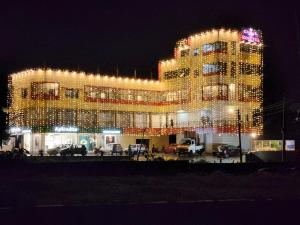 a large building with christmas lights on it at The Rosetta Castle in Kalpetta