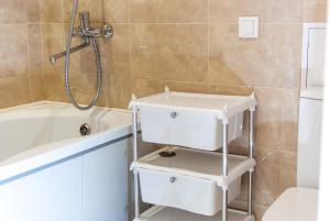 a bathroom with a white sink and a bath tub at Botanical garden area in Kharkiv +62 photos