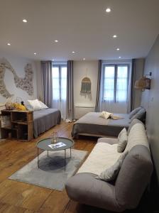 a living room with two beds and a couch at Les Chemins d'Elika in Saint-Jean-Pied-de-Port