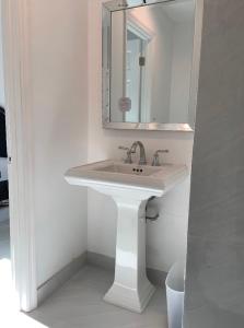 a bathroom with a white sink and a mirror at room & private bathroom in Boca Raton