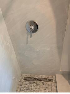a bathroom with a shower with a drain at room & private bathroom in Boca Raton