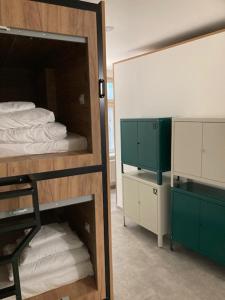 a room with a bunk bed and a mirror at Capsule hostel Andel Centre SPIRIT in Prague