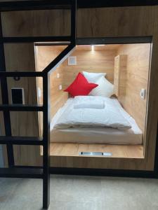 a bedroom with a bunk bed with a red pillow at Capsule hostel Andel Centre SPIRIT in Prague