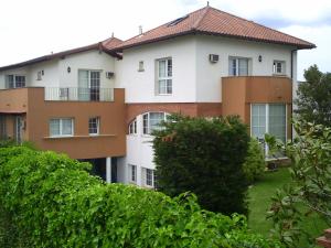 an apartment building with bushes in front of it at Apartamentos Hacienda de Arna in Somo