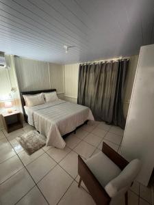 Katil atau katil-katil dalam bilik di Hospedagem Aconchego da casa Rosa